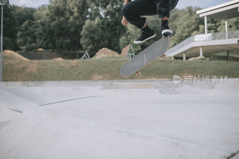 Asian skateboarder in action mid air x games